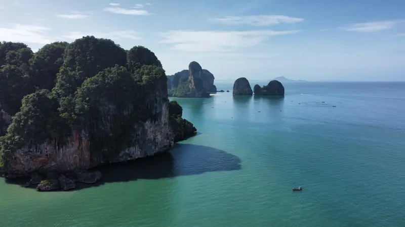 Limestone islands rising from a turquoise sea in Thailand